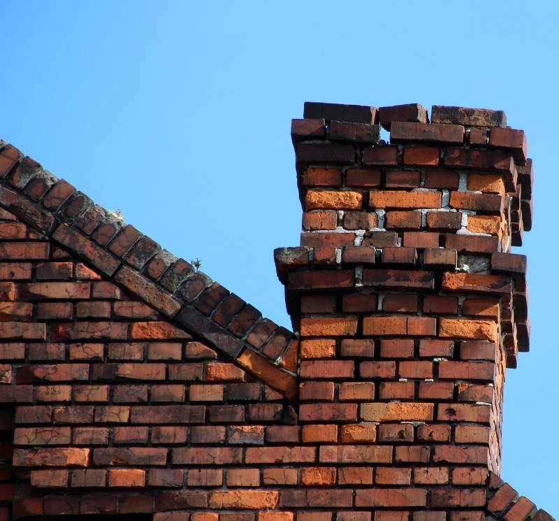 Signs Your Marshfield Home Needs a Chimney Inspection Damaged chimney on an Marshfield home showing cracks and missing mortar